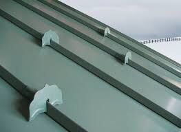 Close-up inside a green seamless gutter showing evenly spaced hidden hangers