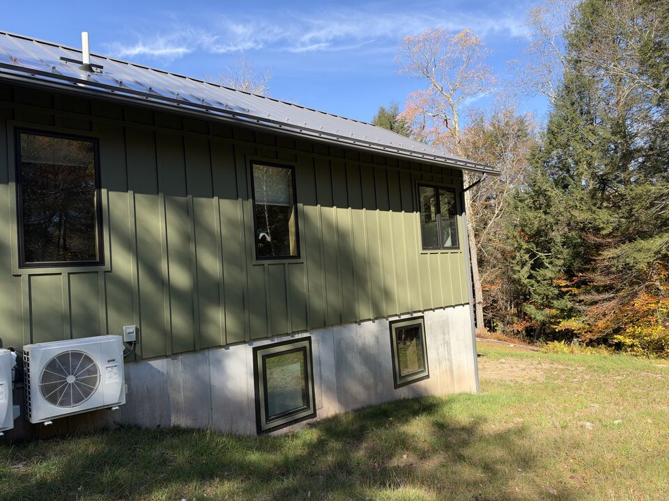 Standing seam metal roof above a seamless gutter run